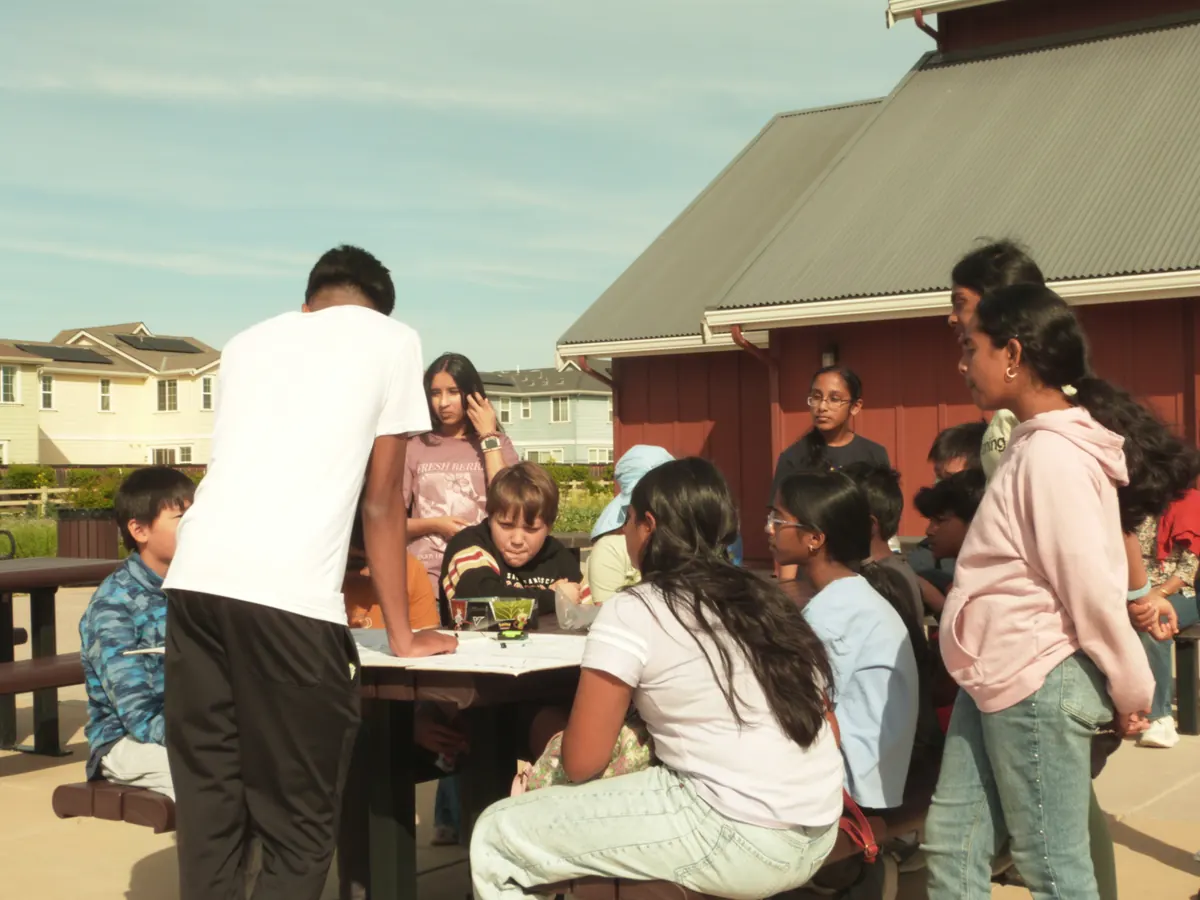 An instructor showing a group of students how a component works